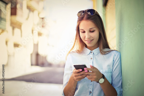Beautiful young woman using a smart phone