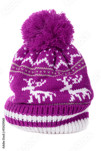 One single pink or purple winter bobble ski knit hat with reindeer pattern isolated on white background winter clothes