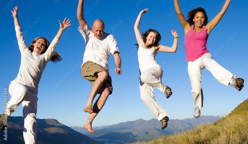 Group of young people jumping in the field Concept