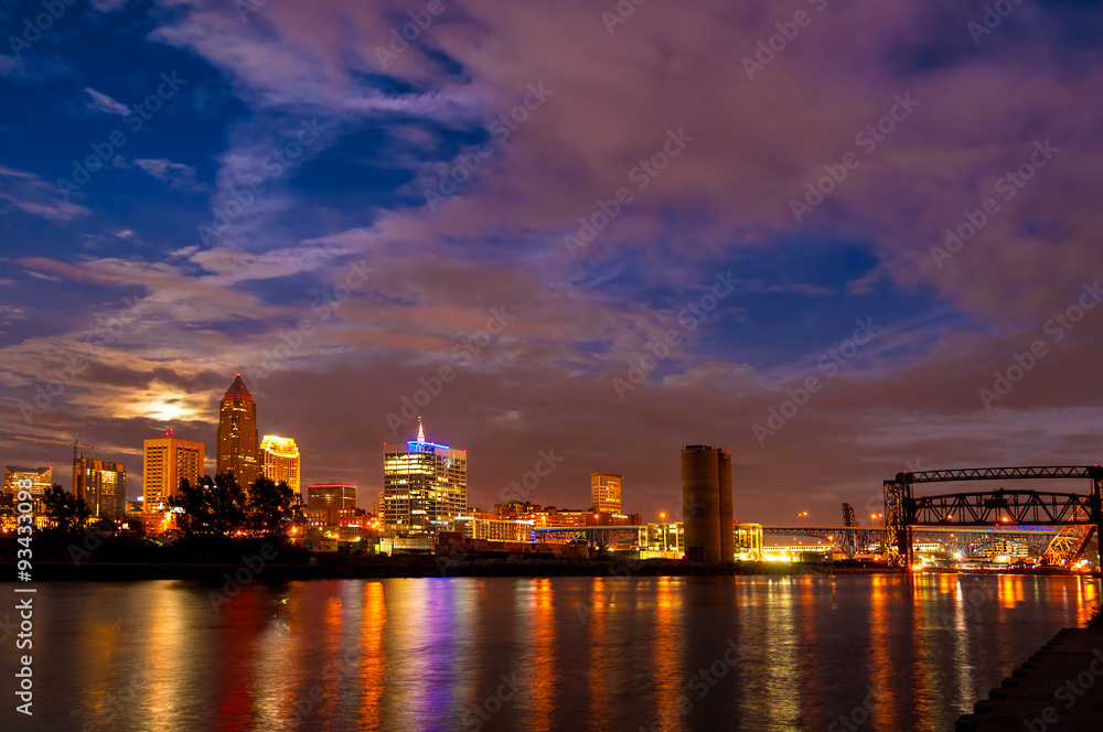 Moonrise over downtown Cleveland Ohio with city lights reflected in the Cuyahoga River
