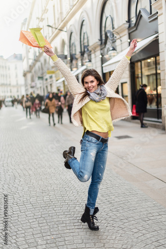 Smiling woman in her 30s with black boots and white coat jumping © jackfrog