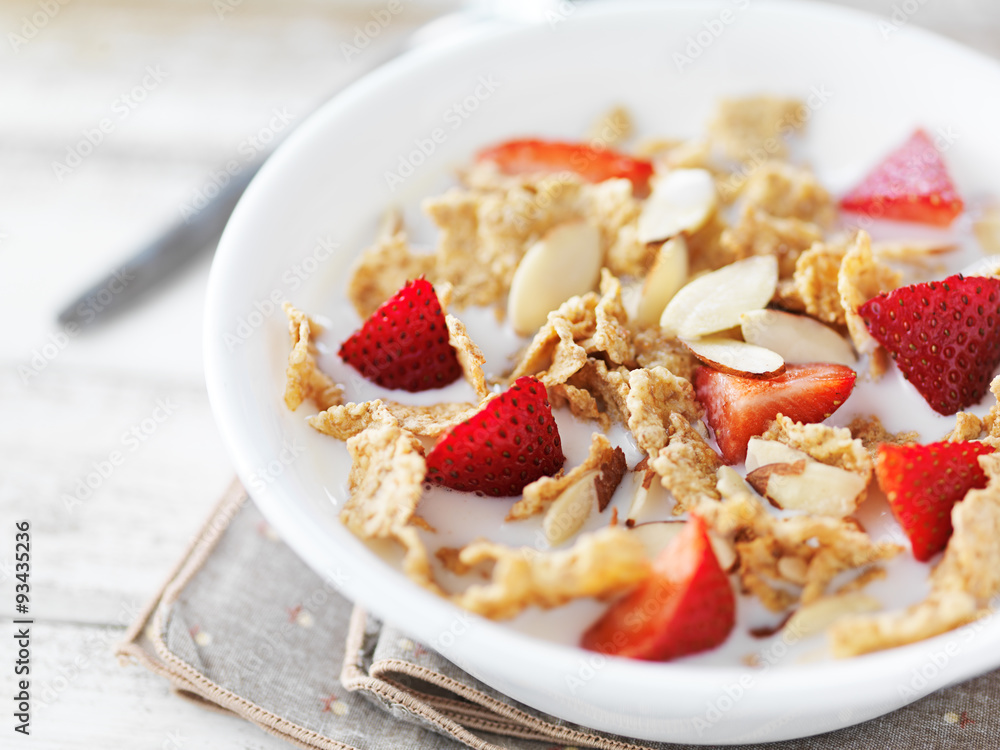 bowl of cereal with strawberries and almonds