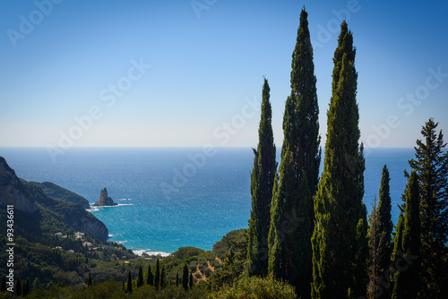 Cypresses and stunning views of the bay of Agios Gordios in Corfu. Greece photo