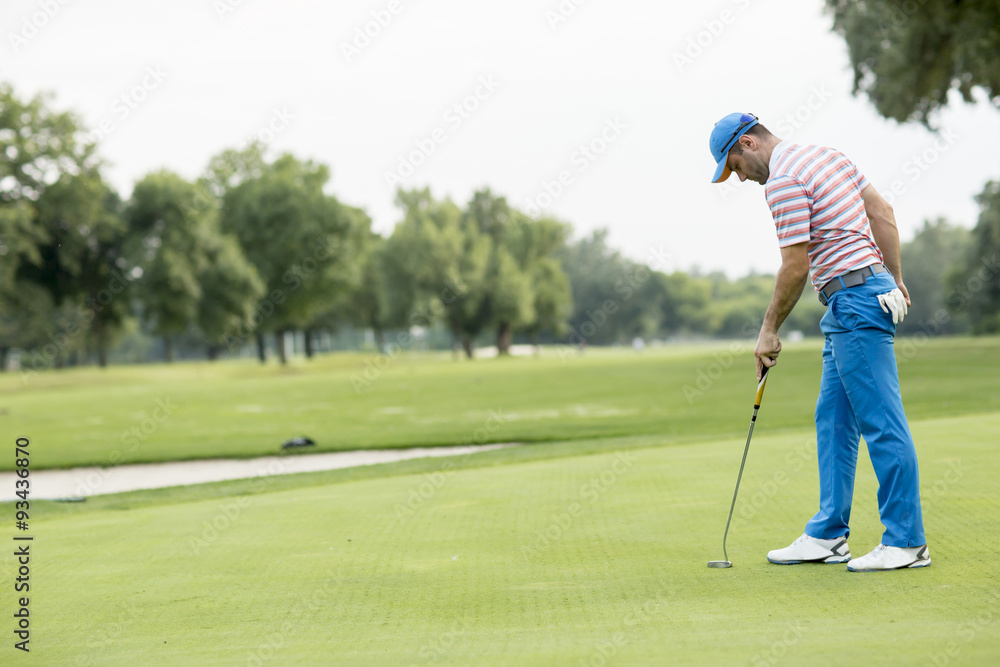Fototapeta premium Young man playing golf