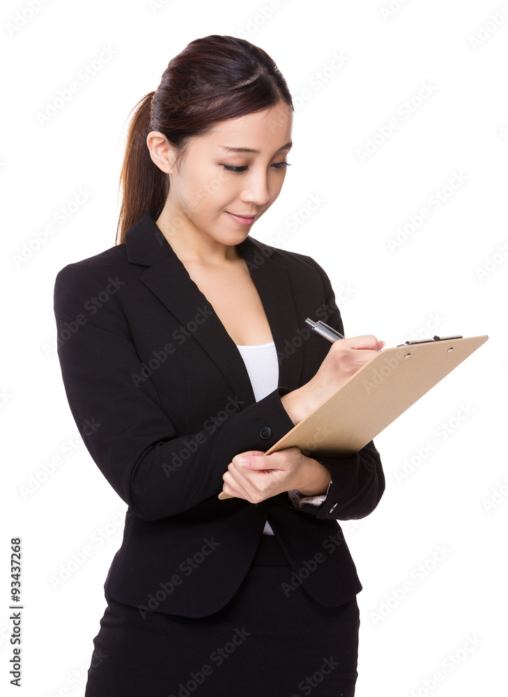 Asian Young businesswoman take note on clipboard Asian Young businesswoman take note on clipboard