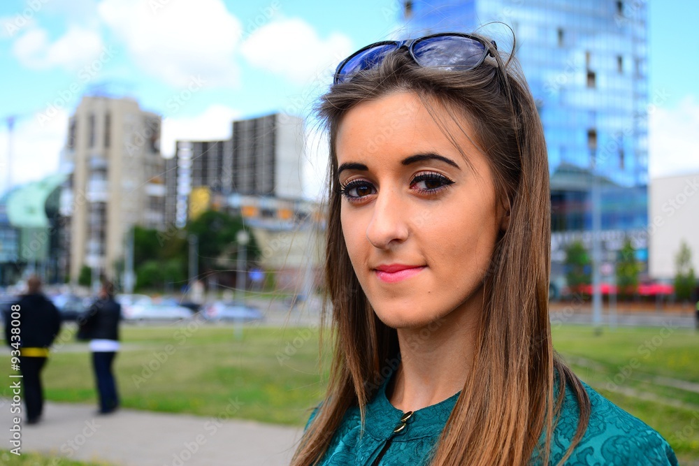 A girl in the city and blue sky and clouds background A girl in the city and blue sky and clouds background