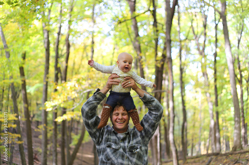 Happy Father Playing with Cute Baby daughter in Autumn Woods