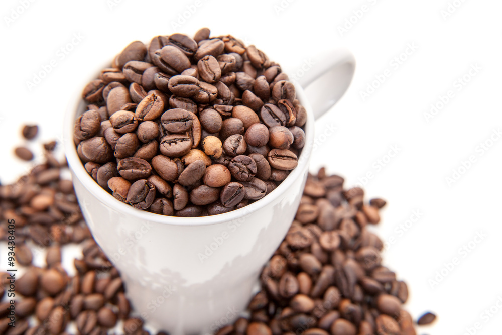 Cup full of coffee beans. All on white background Cup full of coffee beans. All on white background