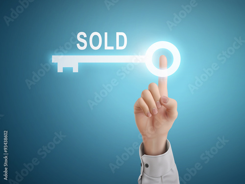 male hand pressing sold key button