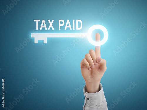 male hand pressing tax paid key button