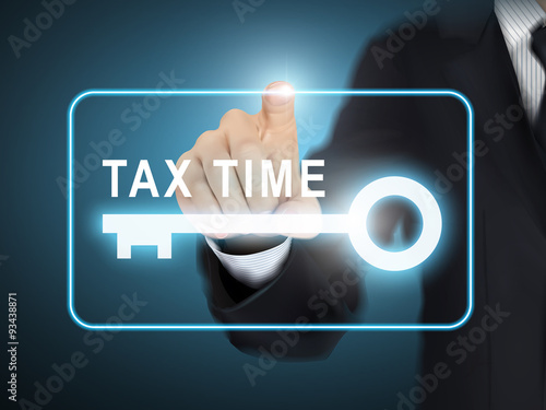 male hand pressing tax time key button