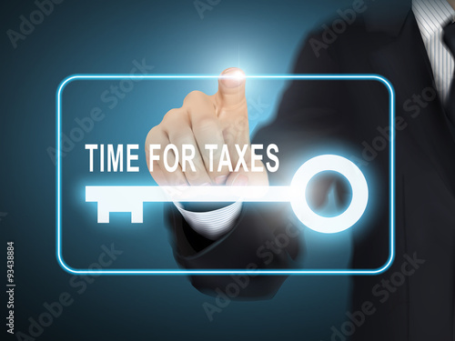 male hand pressing time for taxes key button