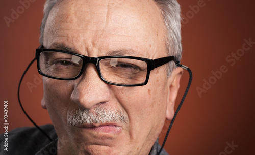man in glasses with a grimace of pain