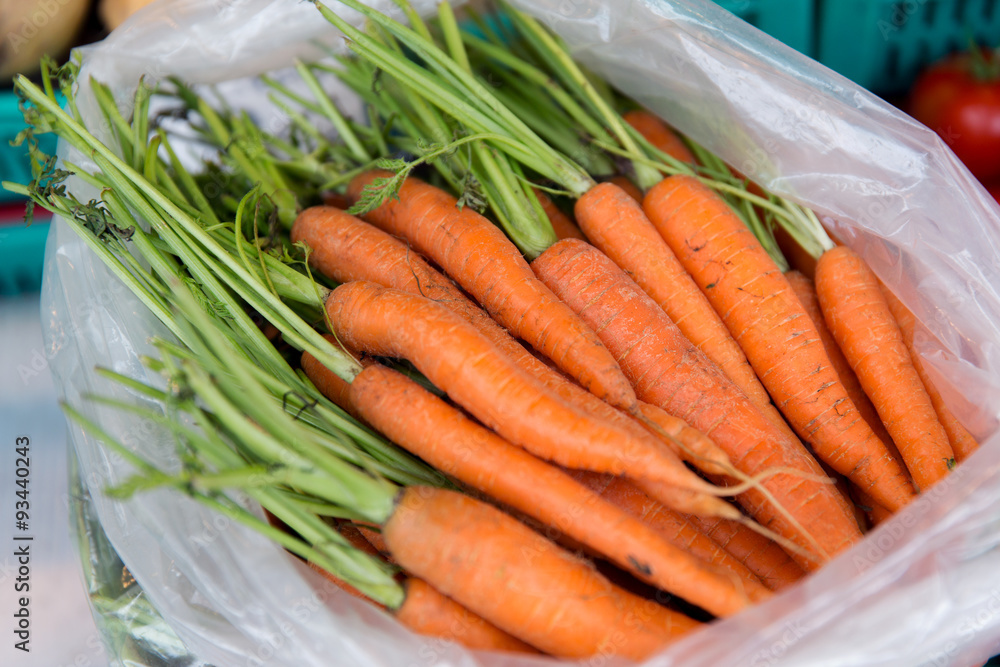 close up of carrot in plastic bag at street market close up of carrot in plastic bag at street market
