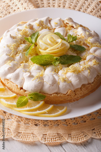 Gourmet Lemon cake with meringue and mint close-up. Vertical 