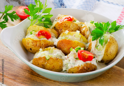 Baked potatoes with vegetables and sour cream.