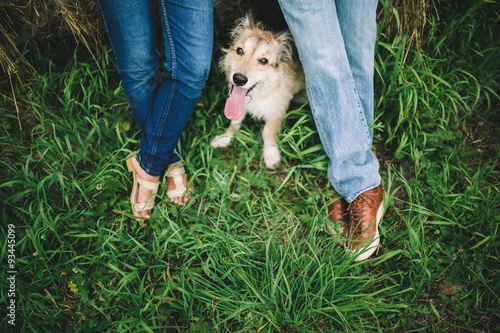 dog and couple on the green grass.