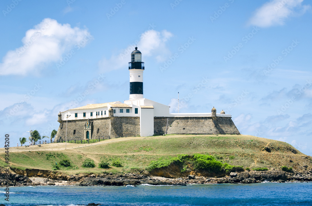 Portrait of the Farol da Barra lighthouse under clear blue sky in Salvador, Bahia, Brazil 