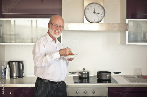 Man eating pasta in the kitchen