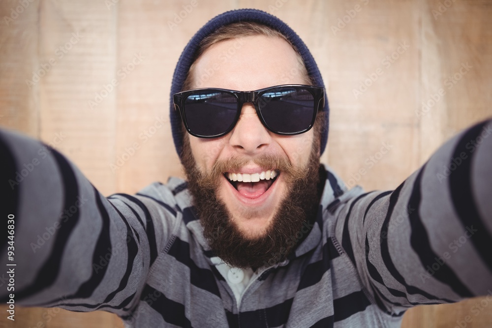 Fototapeta premium Portrait of happy hipster wearing sunglasses