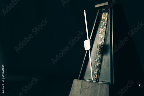 Vintage metronome, on a dark background. photo