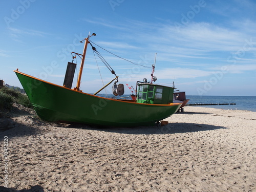 Fototapeta Naklejka Na Ścianę i Meble -  green fishing boat  at  sea coast