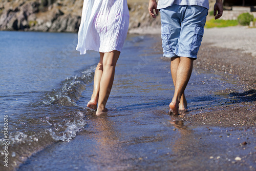 Young couple is walking on the beach