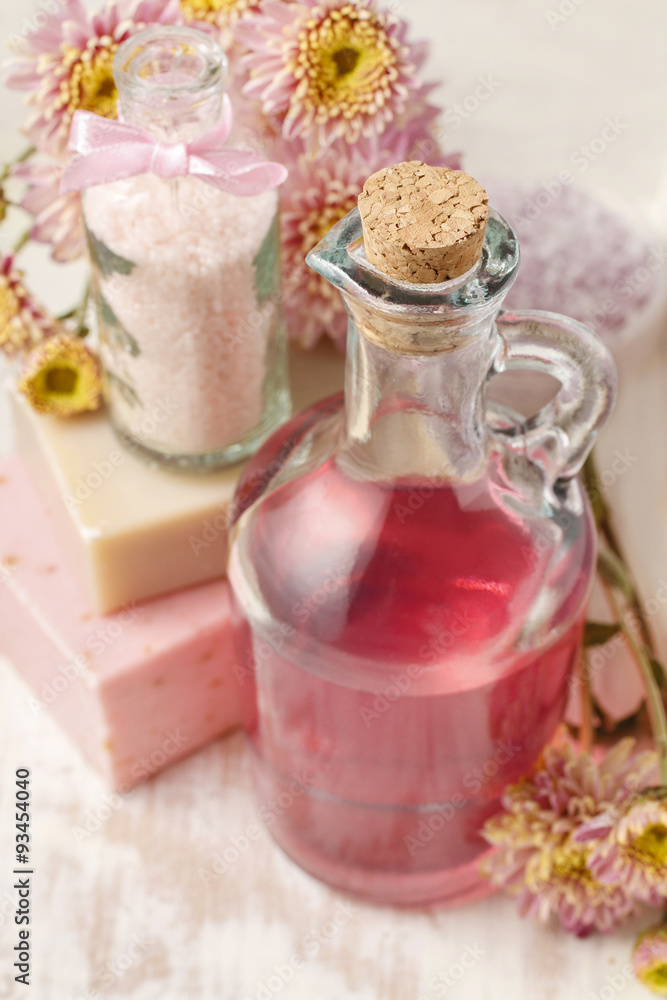 Bottle of pink liquid soap and bottle of sea salt Bottle of pink liquid soap and bottle of sea salt