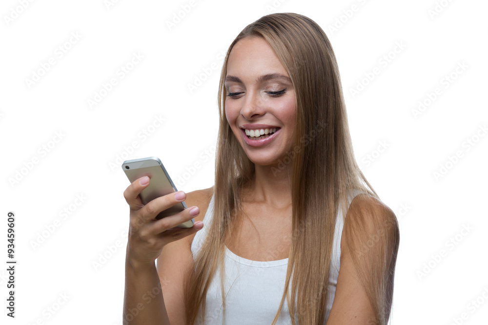 Woman looks at the smartphone screen and smiles Woman looks at the smartphone screen and smiles