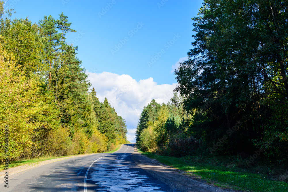 Obraz premium Suburban shosse, old road on sunny autumn day.