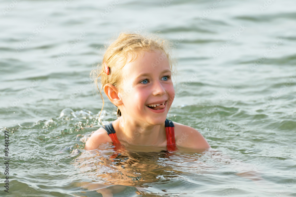 Little girl having fun in the sea.