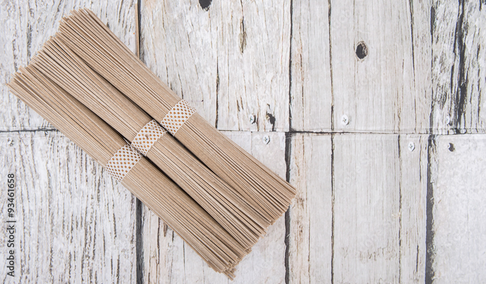 Dried raw soba noodle stick over wooden background