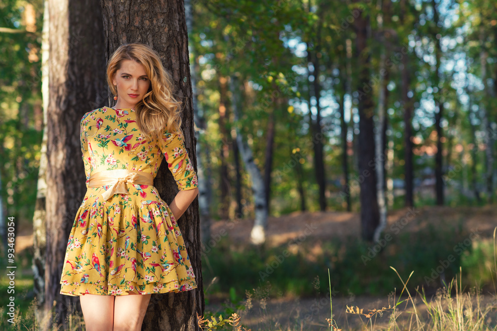 young woman in a yellow dress in the park young woman in a yellow dress in the park