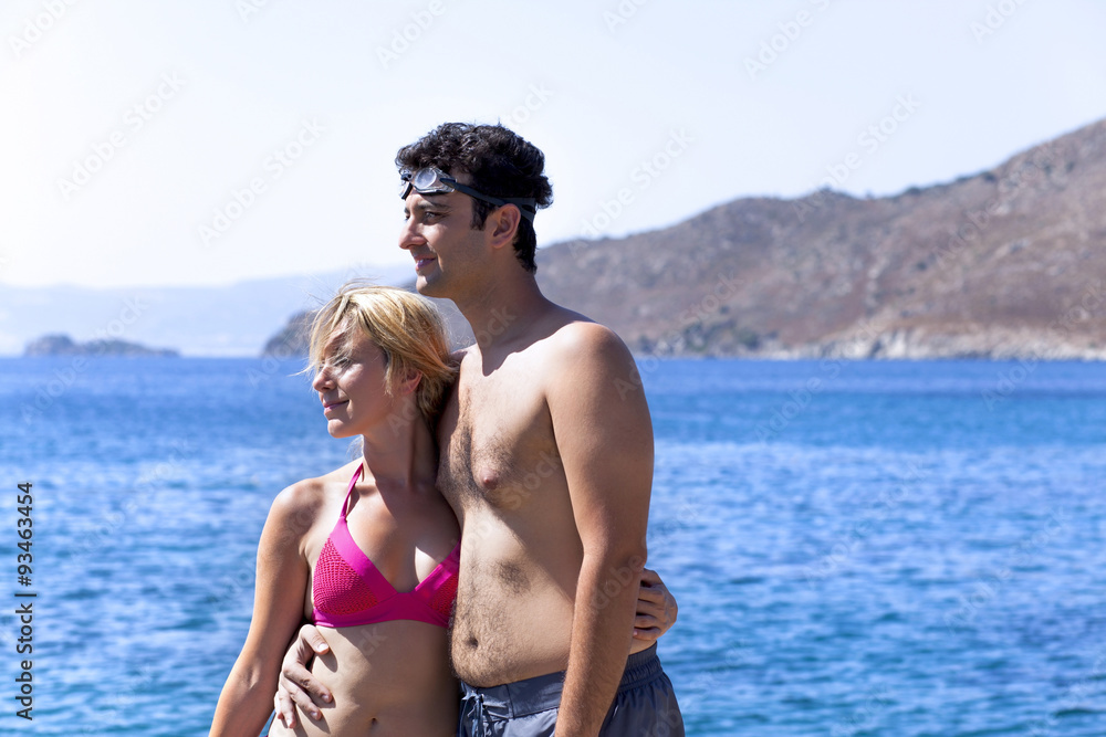 Young couple is holding eachother at sea side