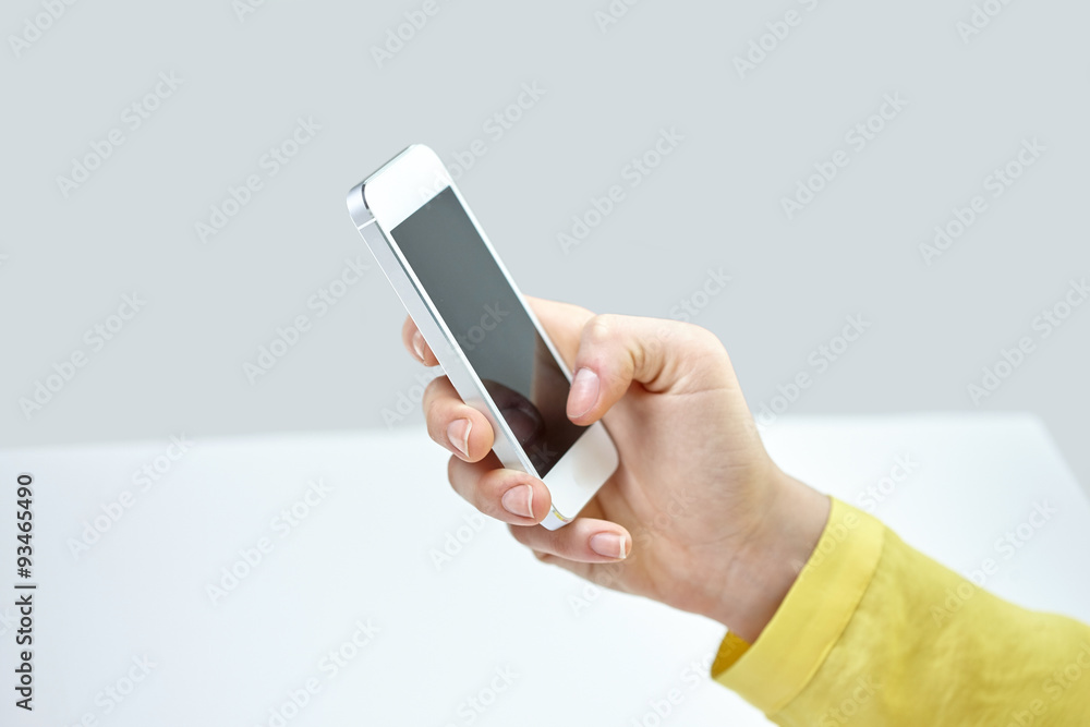 close up of female hand with smartphone at home close up of female hand with smartphone at home