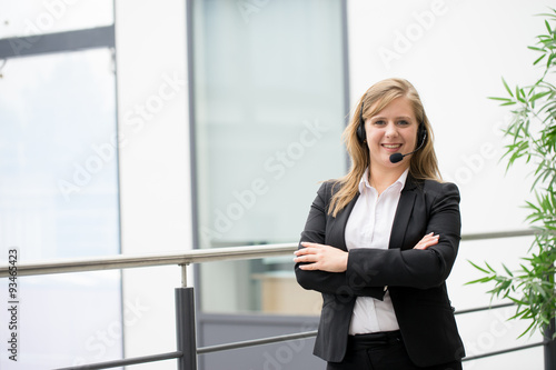 Businesswoman working & sitting at her desk in an office Free Download Businesswoman working & sitting at her desk in an office - GFXLoad