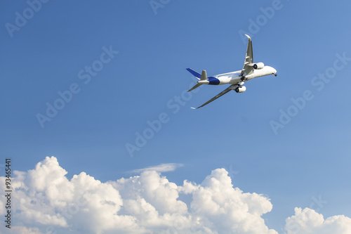 Jumbo jet airplane flying above the clouds. © De Visu