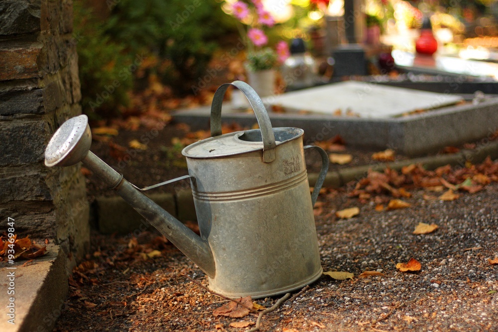 Watering at the autumn cemetery Watering at the autumn cemetery