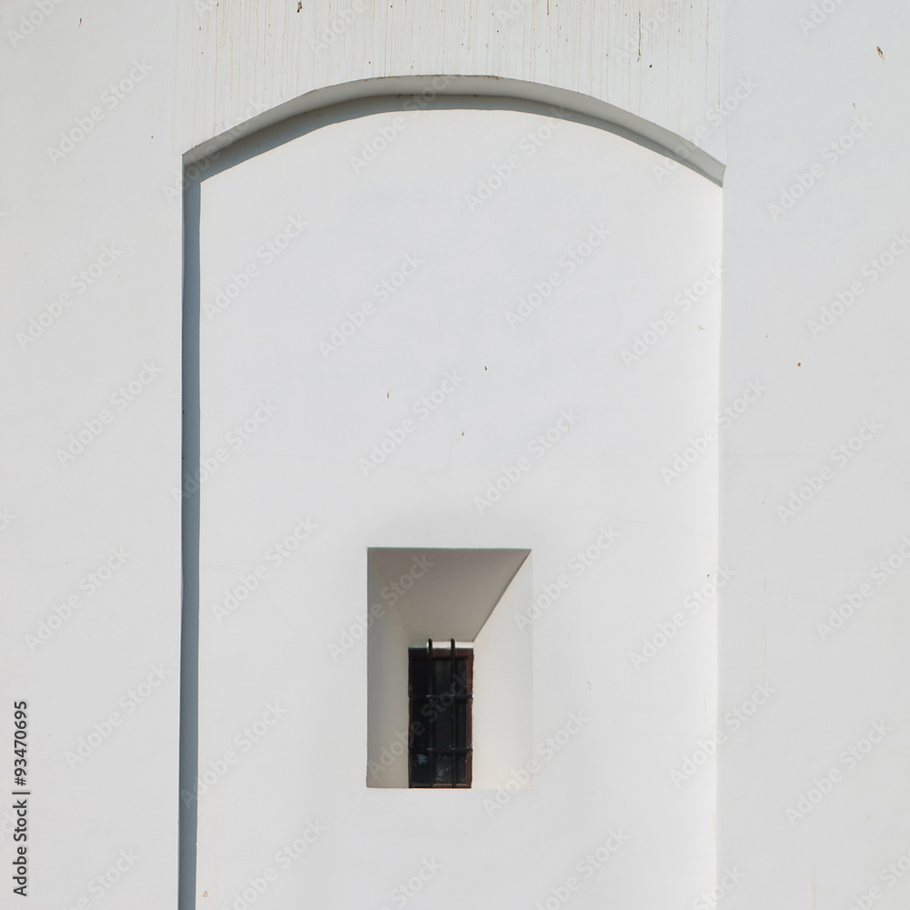 Facade and window. Detail of a church facade with a window Facade and window. Detail of a church facade with a window