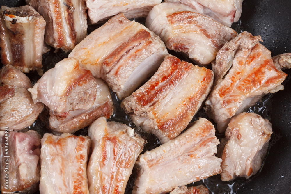 Roasted pork ribs on a black frying pan