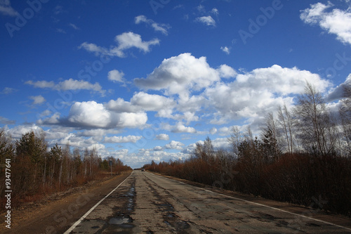 Autumn road and sky with clouds