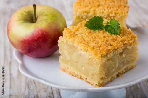 Homemade apple pie on white plate