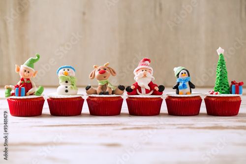 Group of christmas cupcakes on wooden background