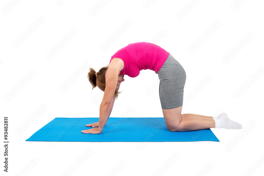 Woman doing gymnastics - cat's arched back Woman doing gymnastics - cat's arched back