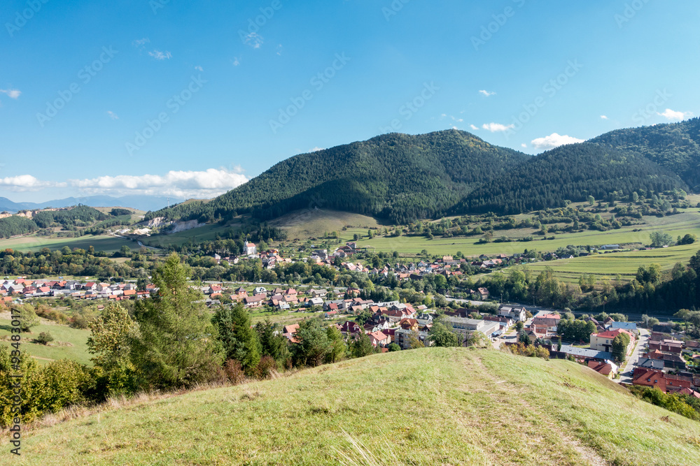 Village under hills and blue sky