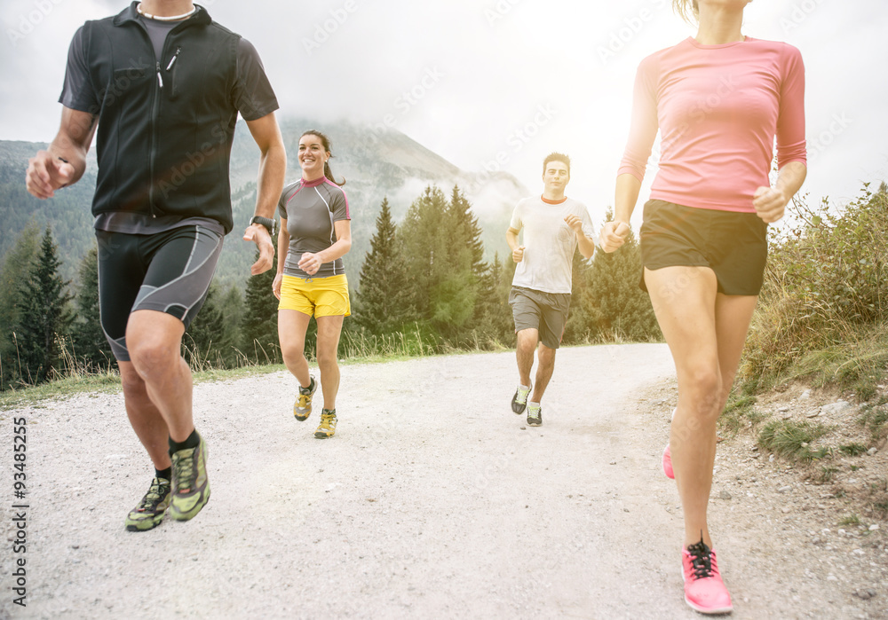 Fototapeta premium Four friends running off road on the mountains