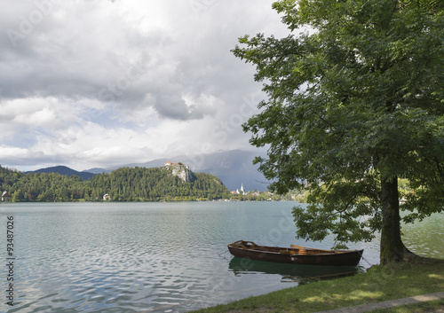 Boat moored in tree shade on Lake Bled.
