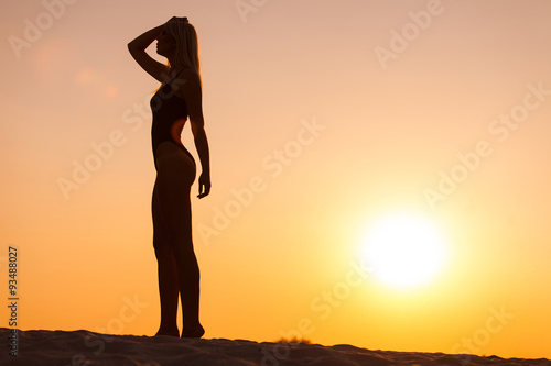 woman silhouette on sunset background