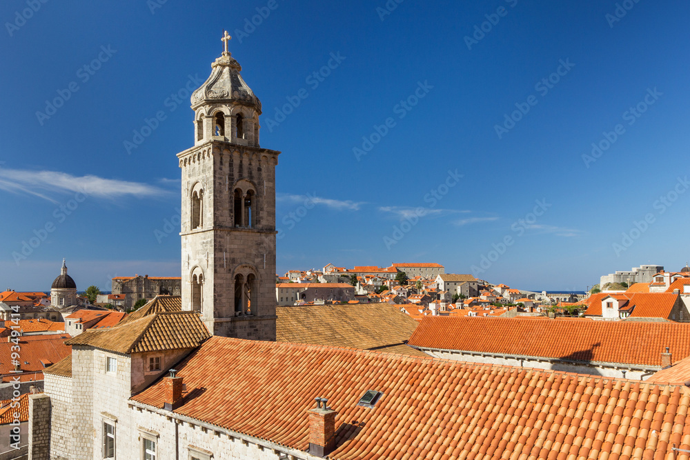 Fototapeta premium Dominican Monastery's bell tower and red roofs at the Old Town in Dubrovnik in Dubrovnik, Croatia. Copy space.