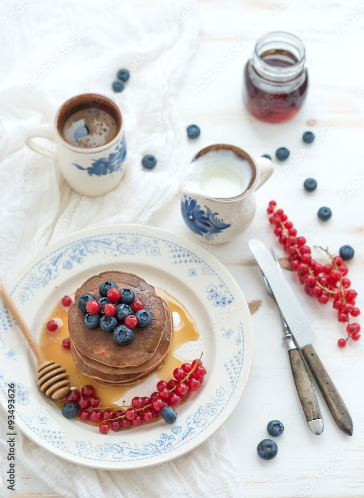 Breakfast set. Buckwheat pancakes with fresh berries, honey
